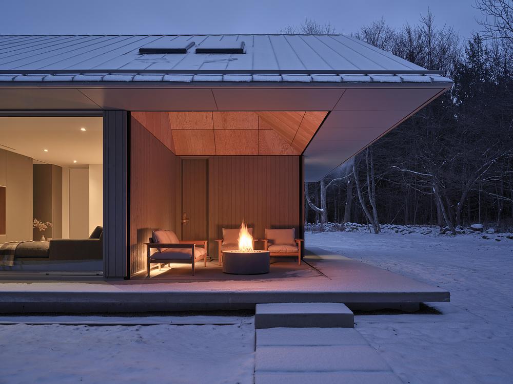 Superkül integrates Ridge House with landscape through sloping roof -