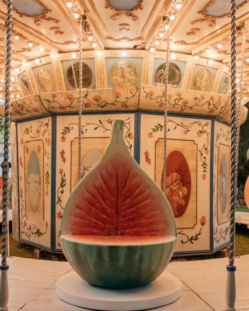 Arket and Laila Gohar transform carousel with oversized food sculptures in Milan -