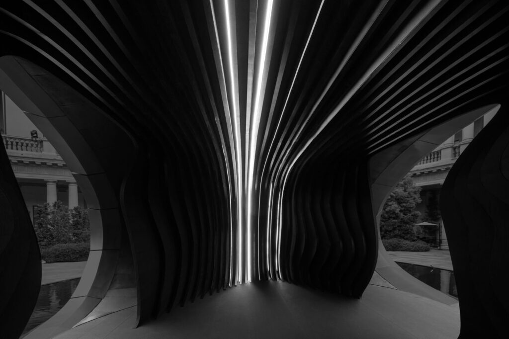 Interior passage of Origin installation showing controlled light and spatial compression