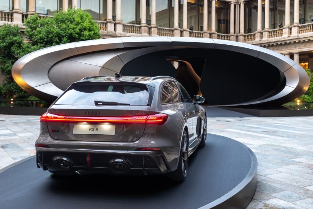 Audi RS 5 plug in hybrid displayed alongside Origin installation Milan