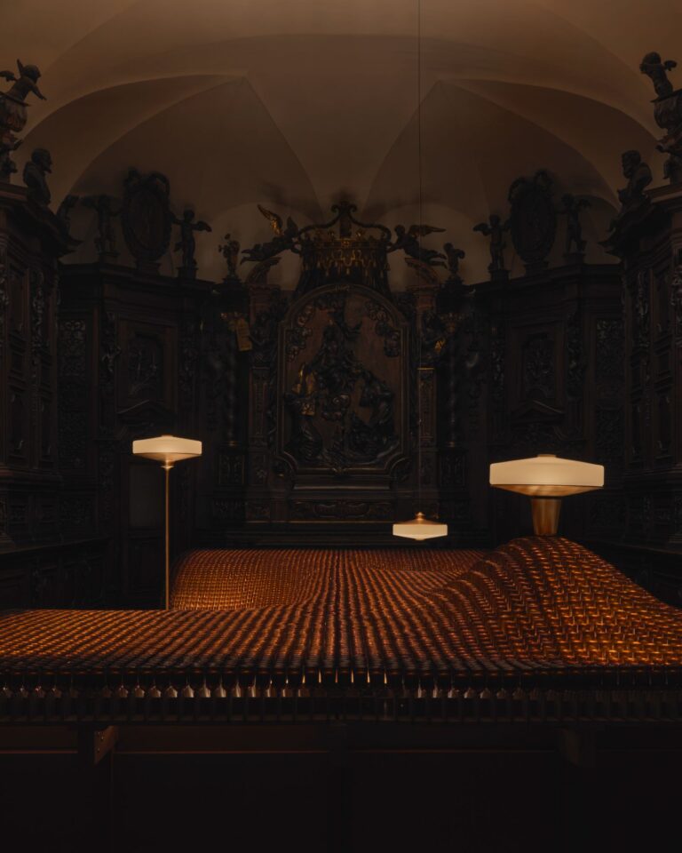 Aesop Factory of Light installation reveals Aposē lighting in Milan Installation of 10826 amber Aesop bottles reflecting light in sacristy