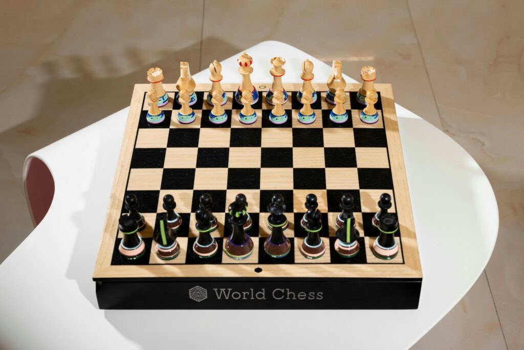 Hand-painted chess pieces with biomorphic engravings on walnut and maple championship set