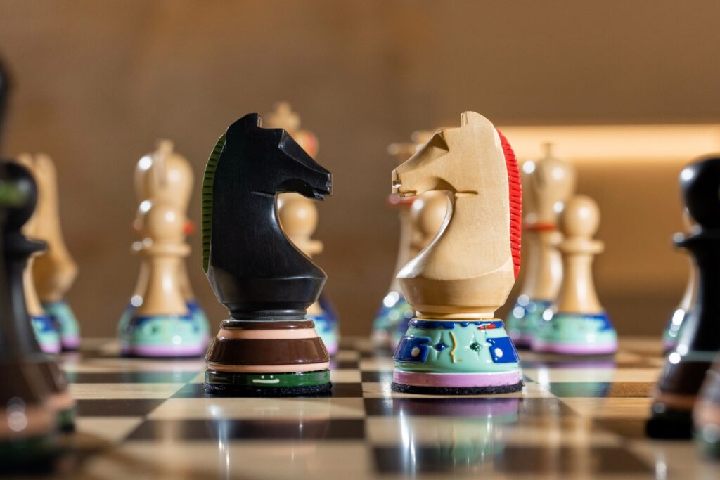 Detailed view of chess figures with carved markings and biomorphic distortions
