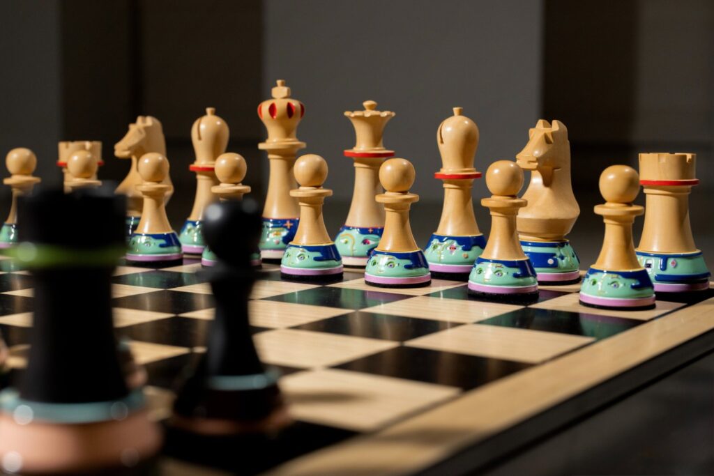 Chessboard composition showing arrangement of pieces across veneered surface in gameplay layout