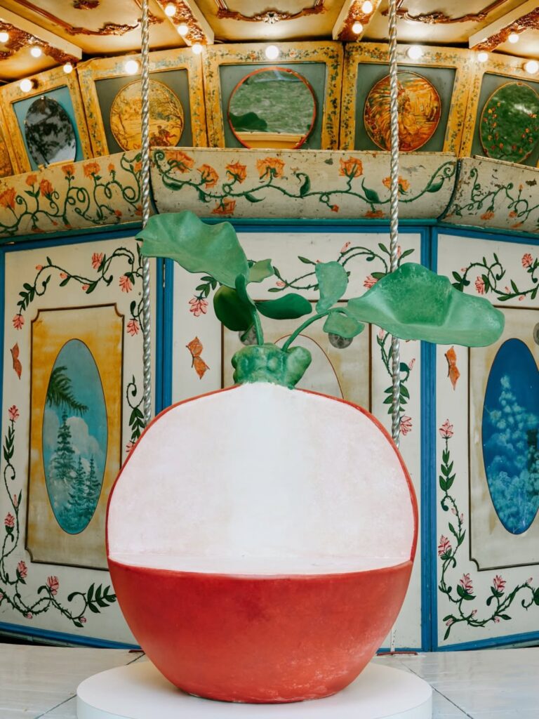 Arket and Laila Gohar transform carousel with oversized food sculptures in Milan -