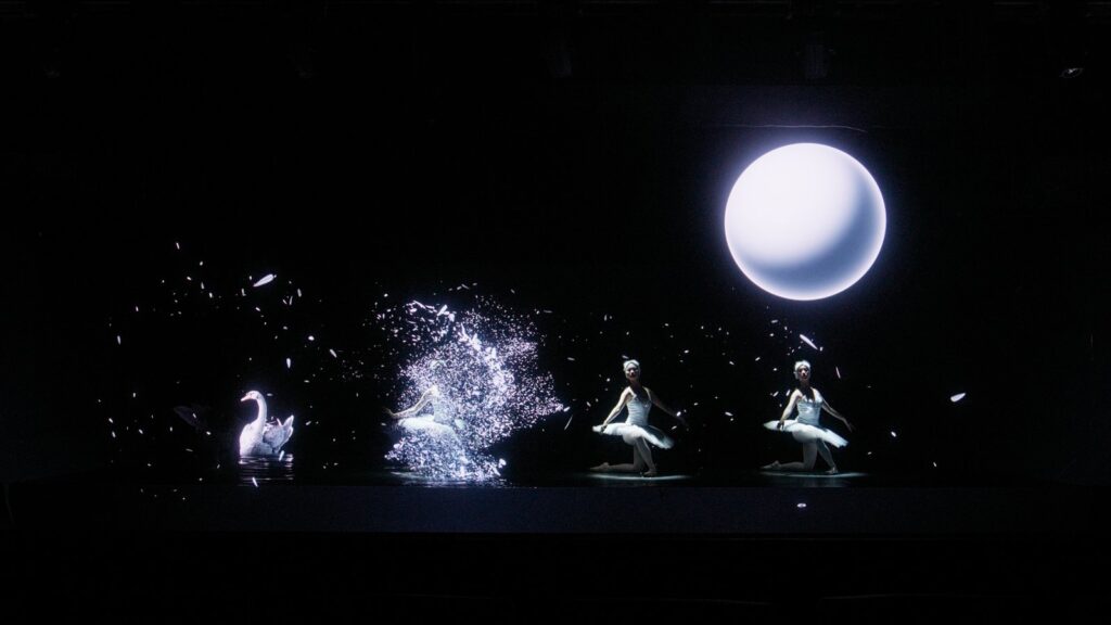Ballet performer moves through black and white digital scenery inside the Holographic Space