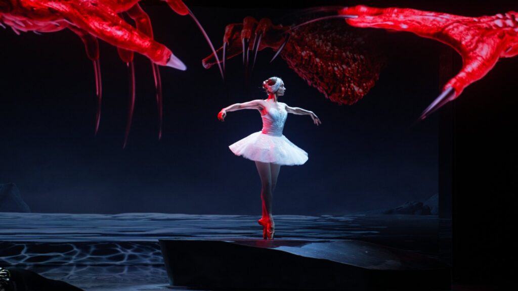 Red clawed hands appear across the floor projection during Rothbart’s scene at Digital Art Gallery D+