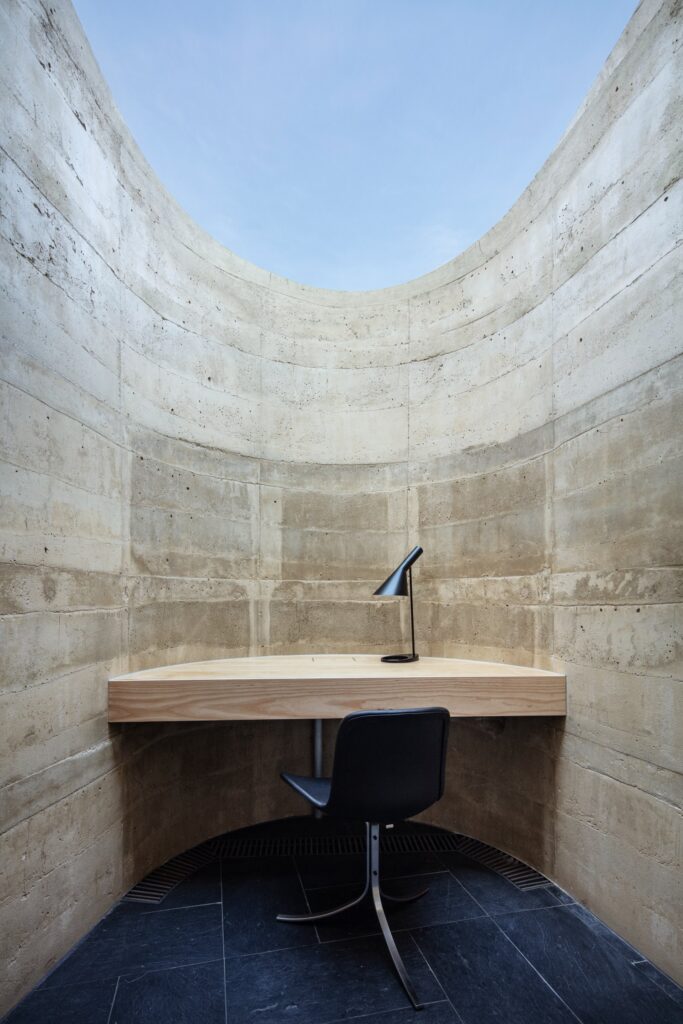 Traditional Japanese bath positioned beside full-height glazing