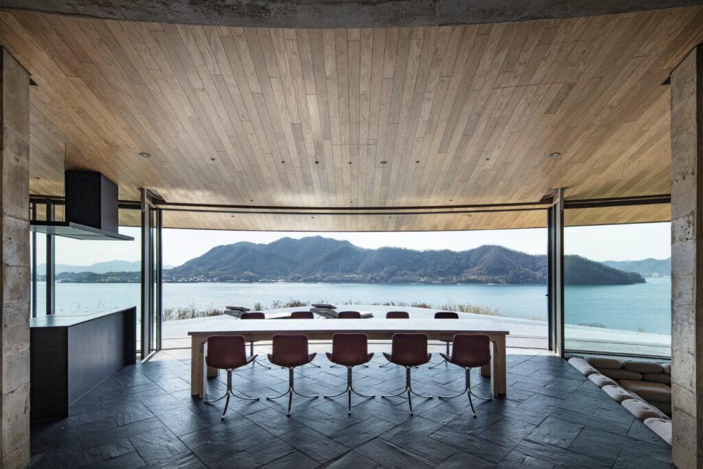 Glass-fronted living space opening toward the surrounding archipelago