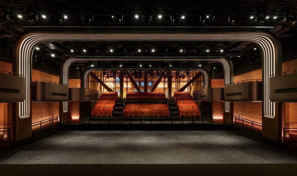 600-capacity performance space with illuminated arches, brick walls and tiered seating