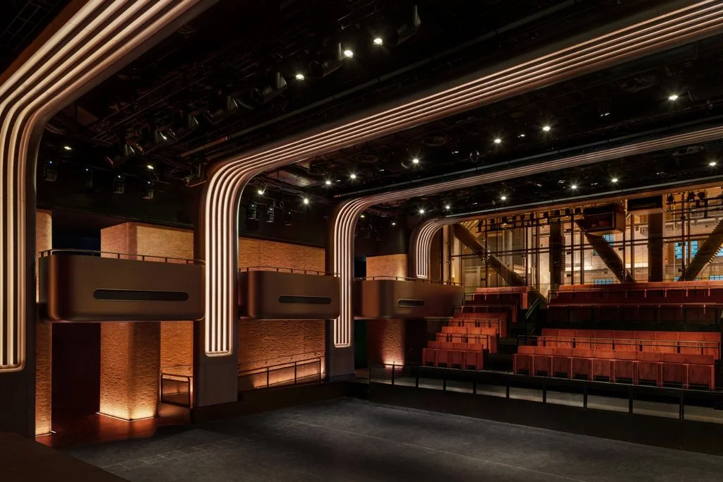 Interior view of the concert hall showing bronze balconies and flexible audience seating