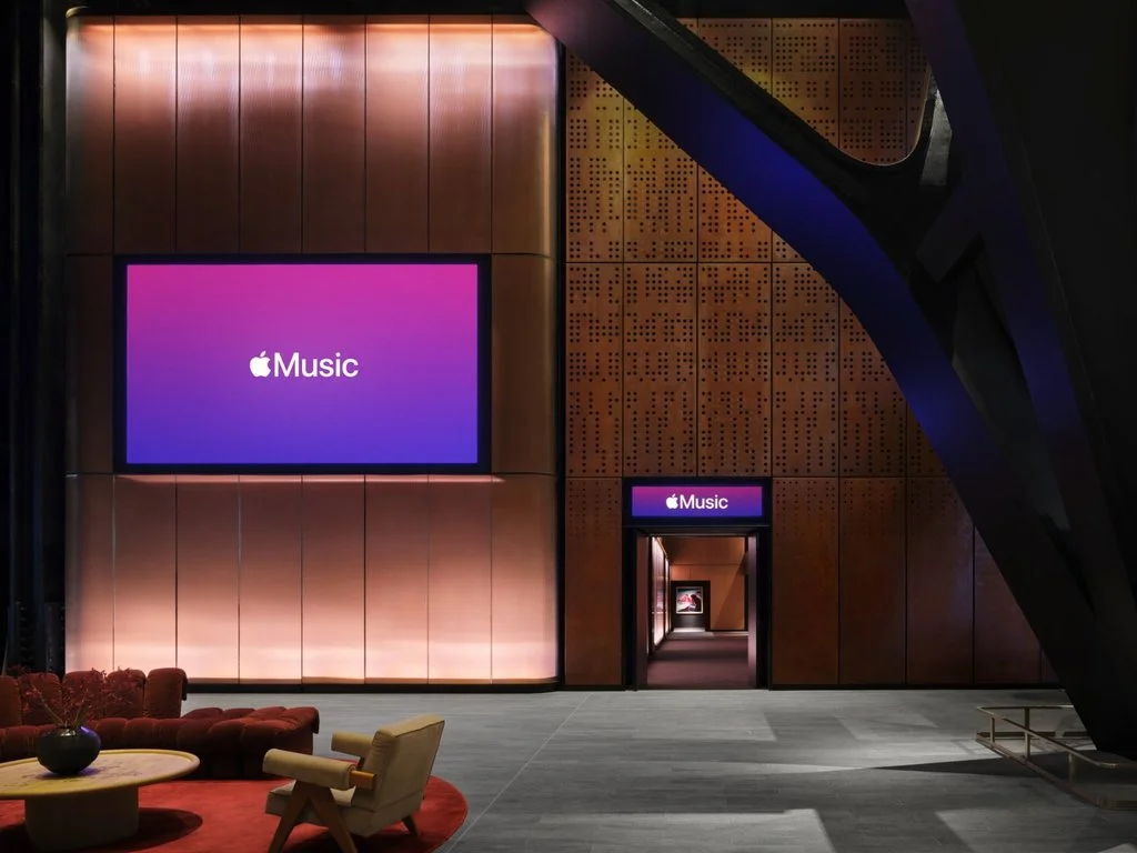 Foyer entrance with Apple Music signage and bronze wall panels