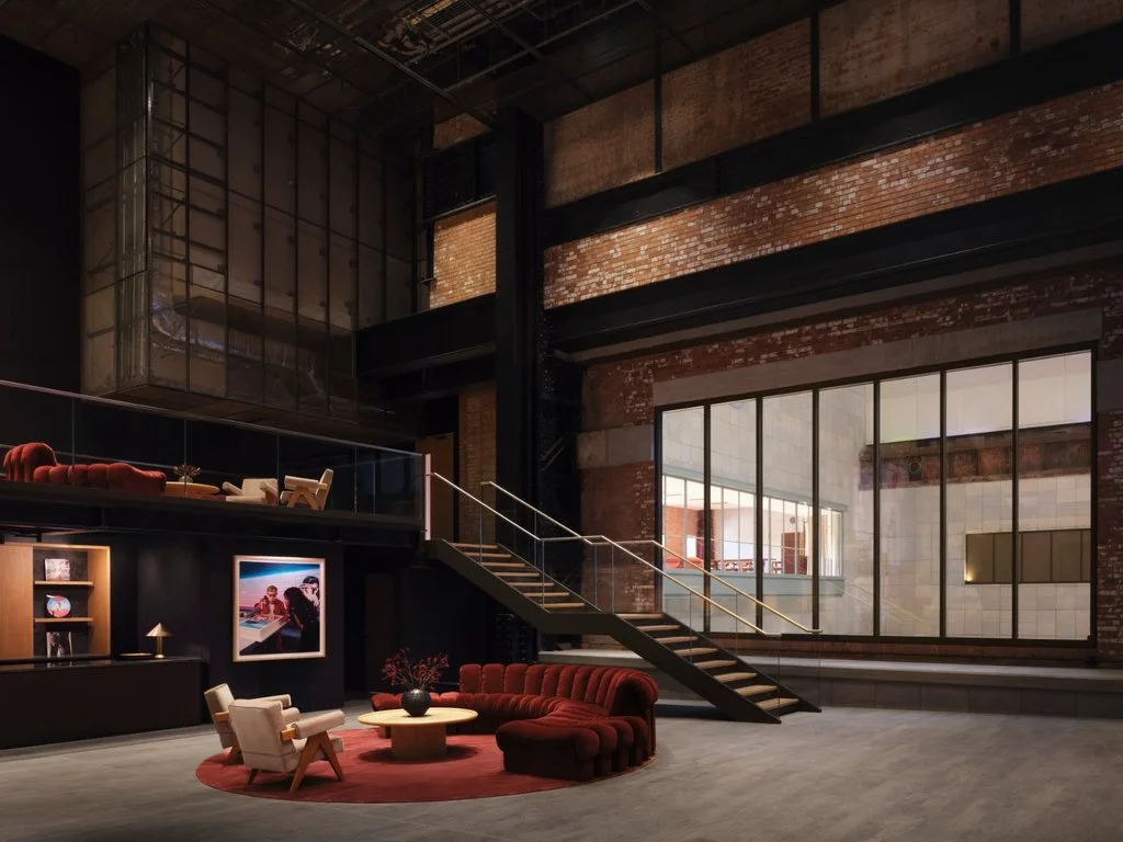 Lounge area combining exposed brickwork, steel structure and contemporary furniture