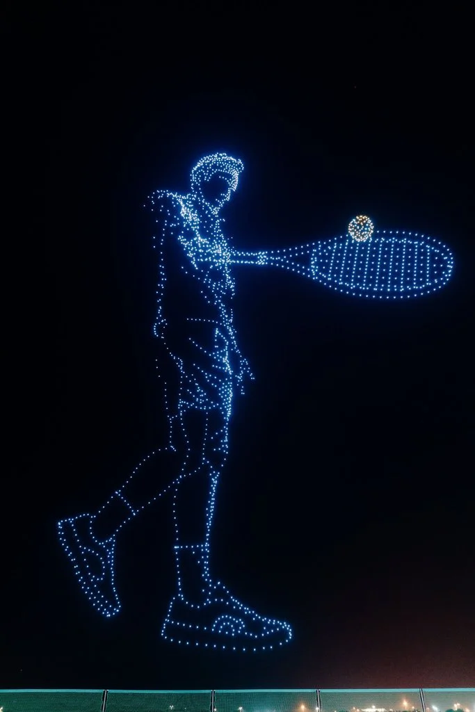 Illuminated drones form a tennis player holding a racket during On and Roger Federer event in Shenzhen