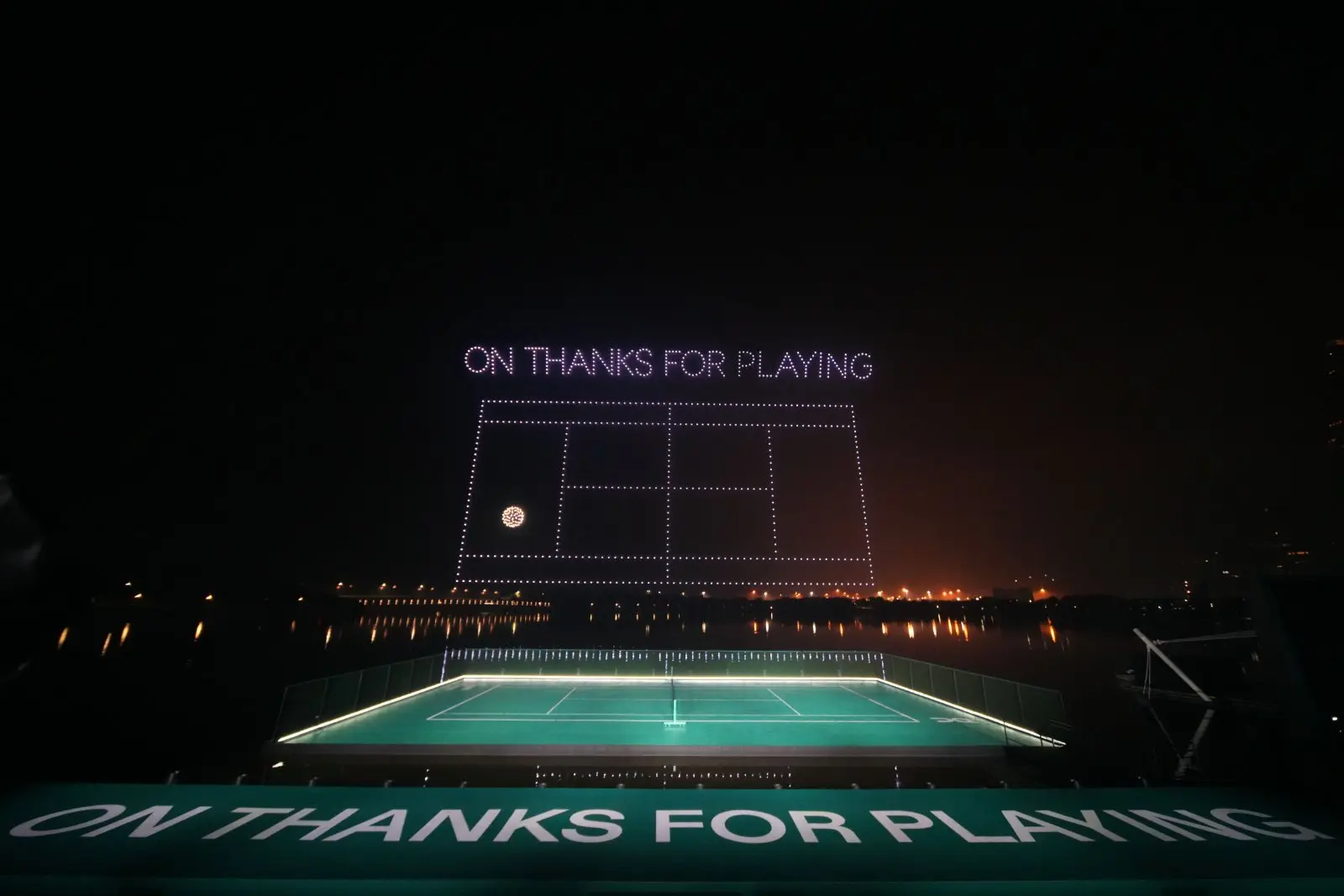 Drone show displays a tennis court and On Thanks for Playing message above Shenzhen waterfront