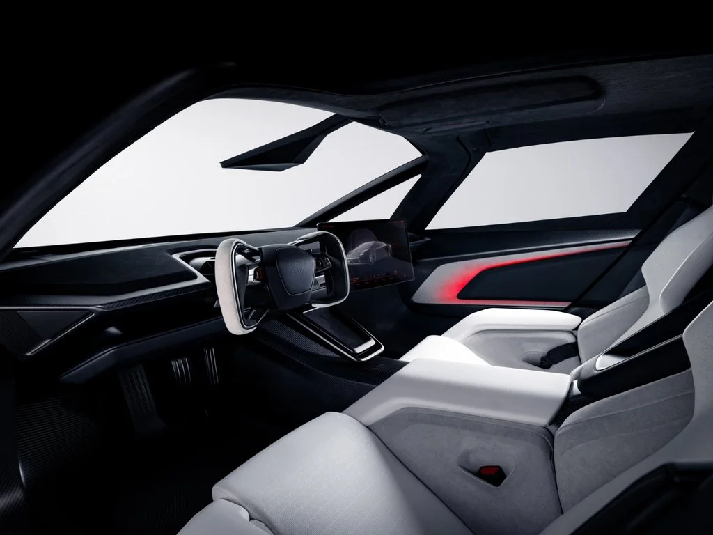 esla Roadster interior featuring white sports seats, steering yoke and central touchscreen