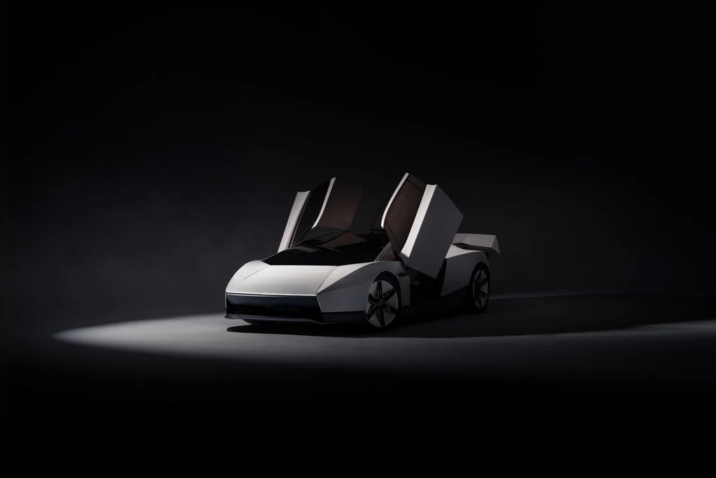 Tesla Roadster concept car with upward-opening doors, sculpted silver bodywork and a streamlined front design